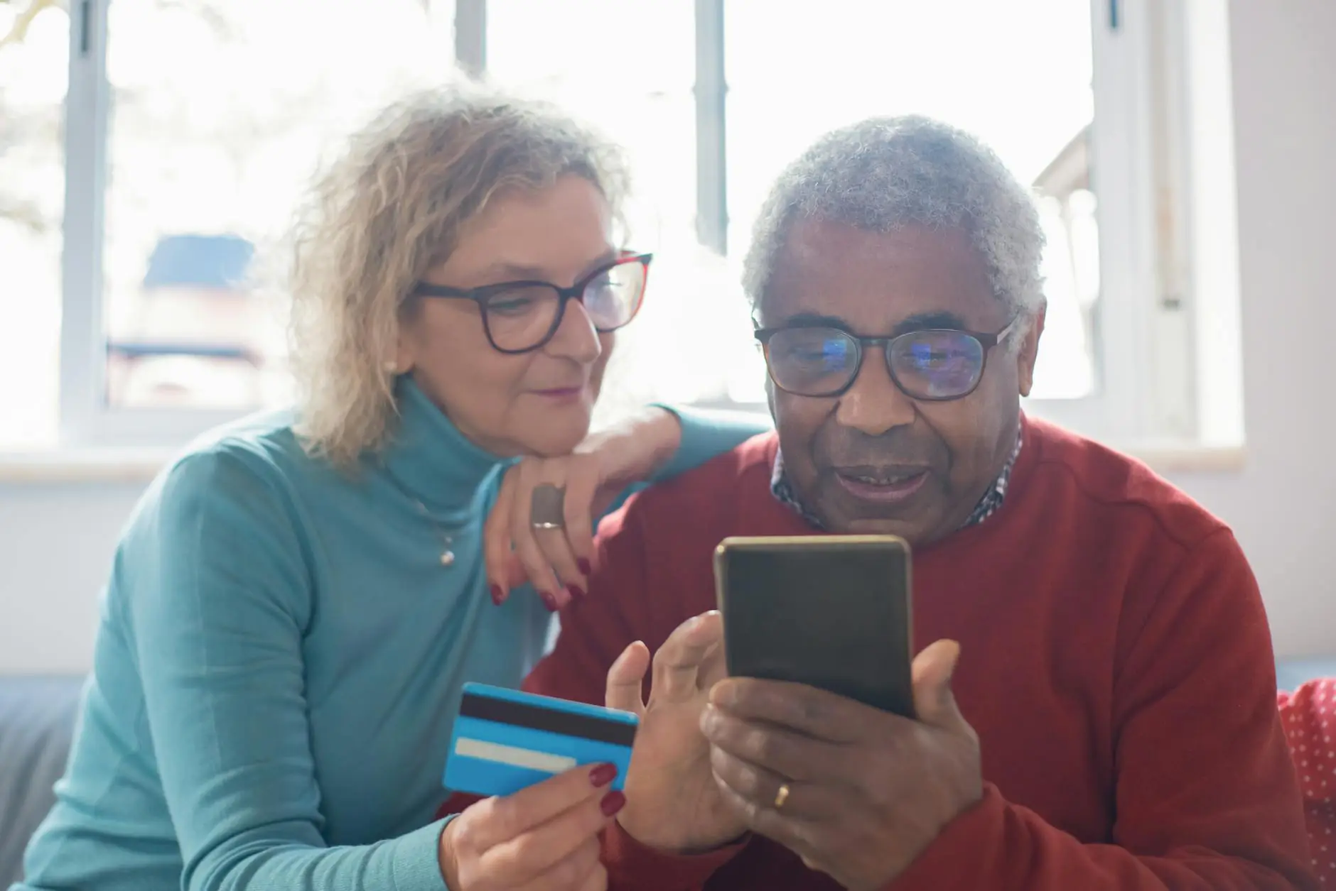 an elderly couple shopping online