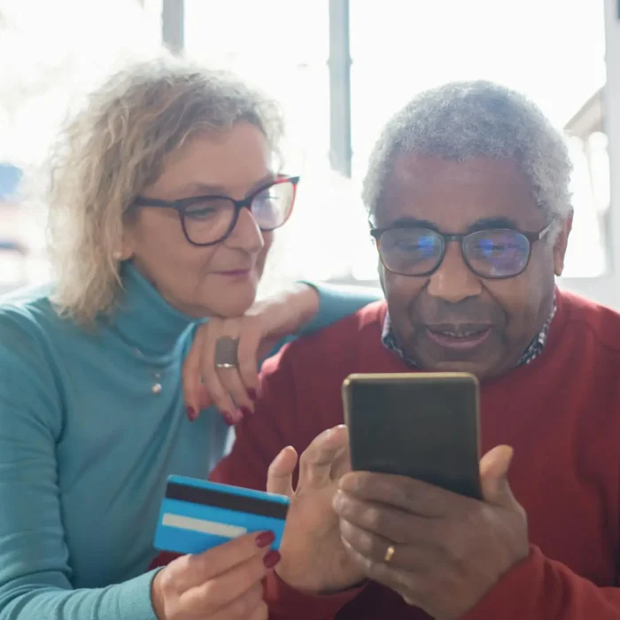 an elderly couple shopping online